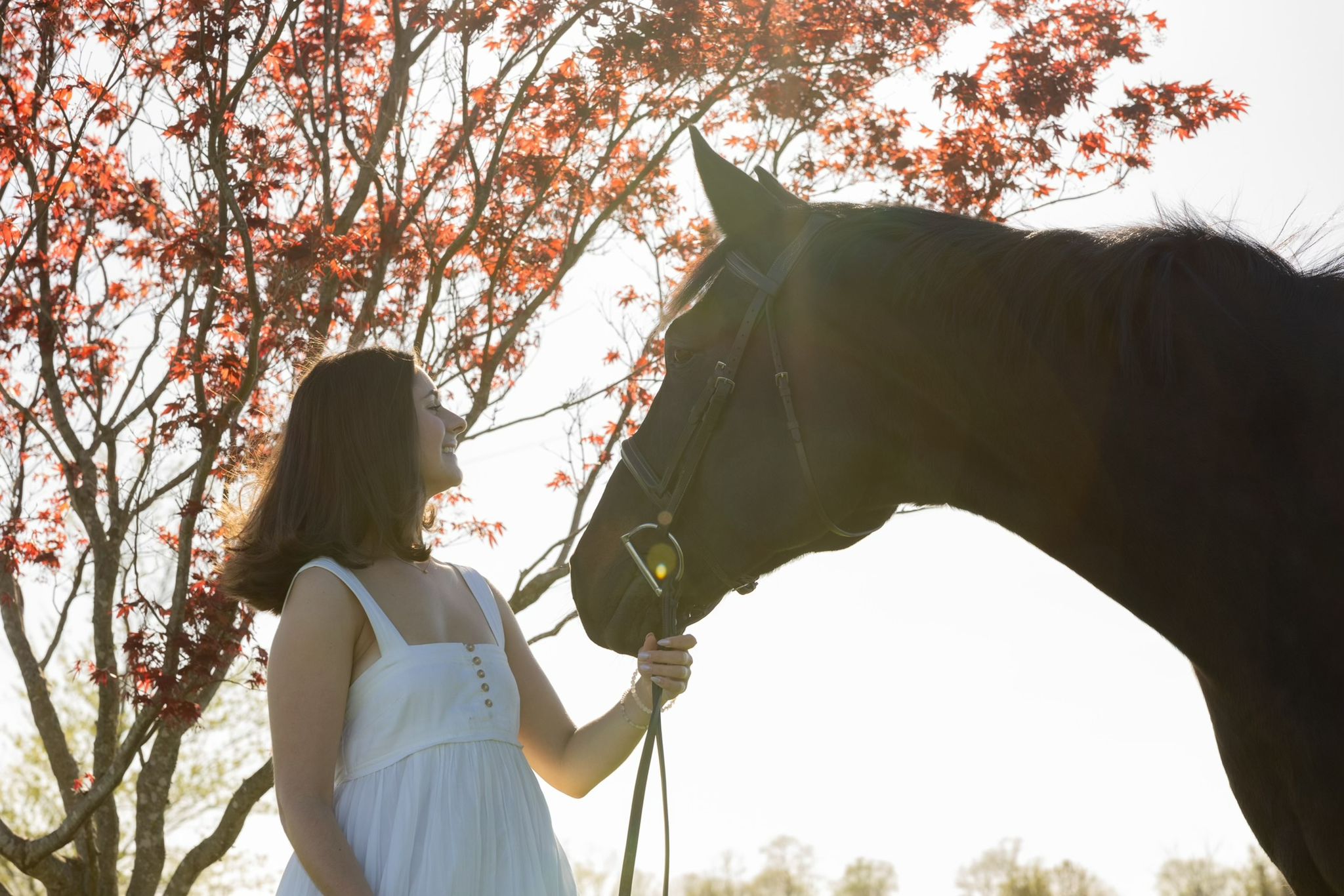 Chloe with horse under autumn tree