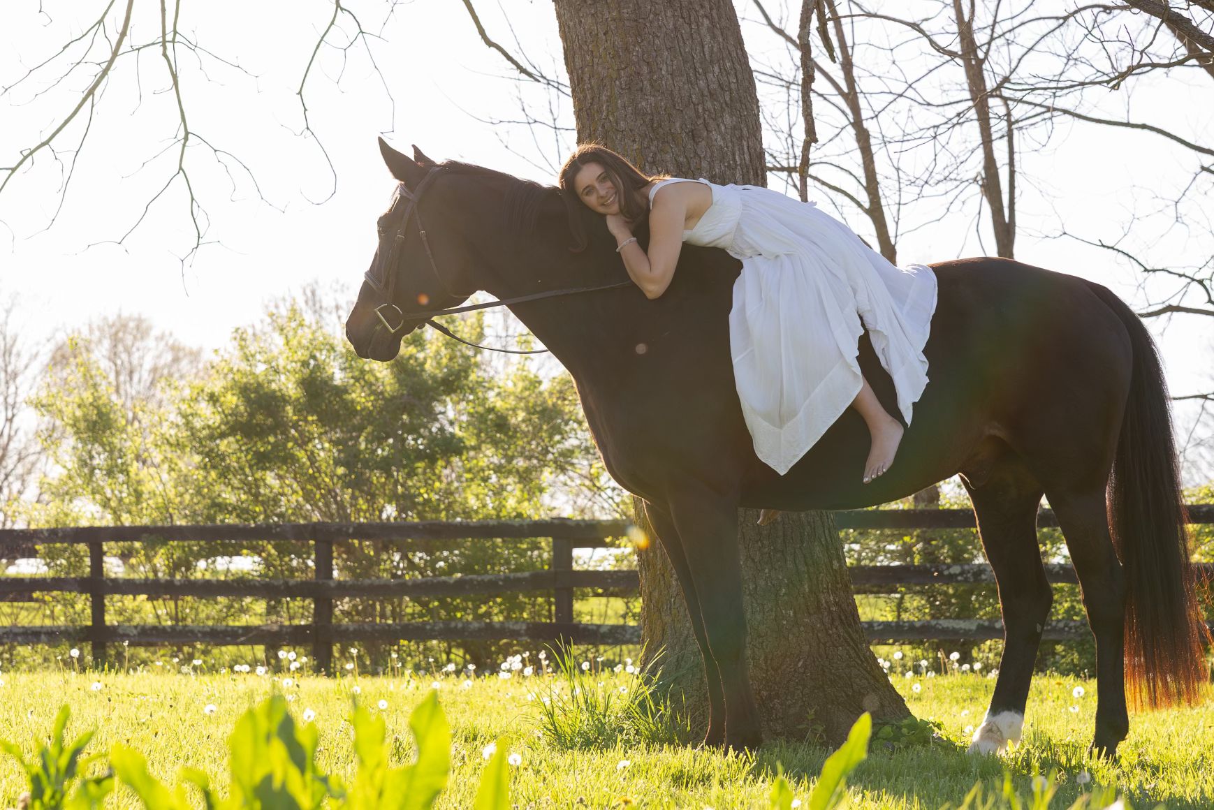 Chloe riding bareback in a white dress