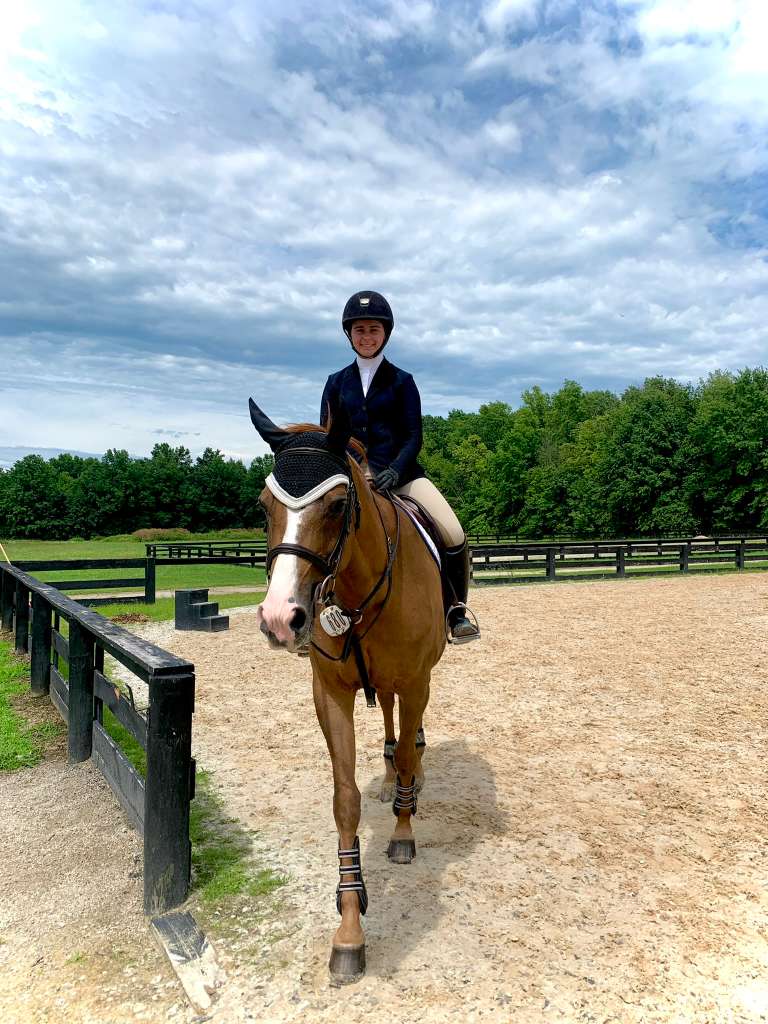 Chloe riding in an outdoor arena